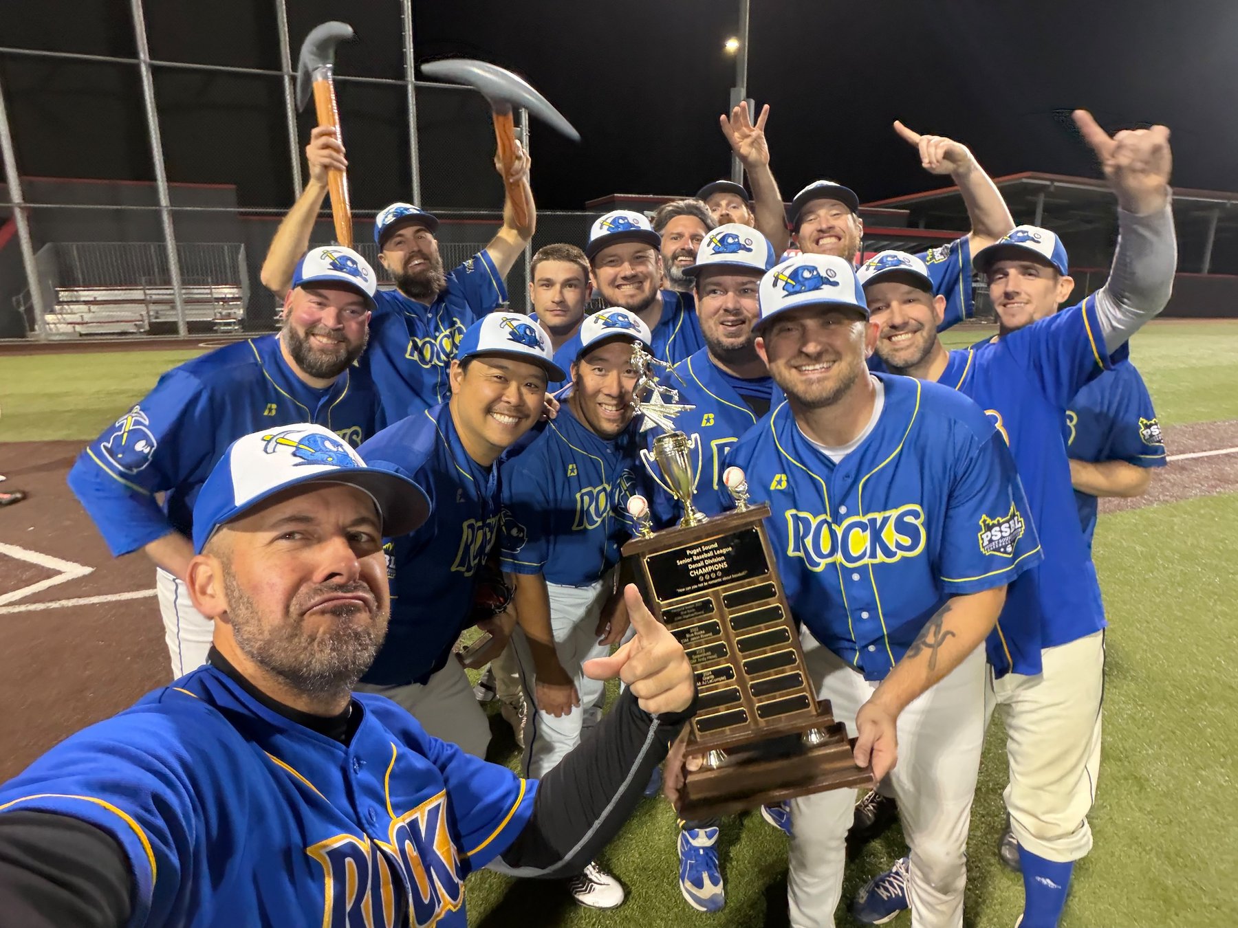 PSSBL Denali Blue Rocks celebrating on the field with the championship trophy and pickaxes